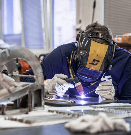 construction worker welding arabela chandelier